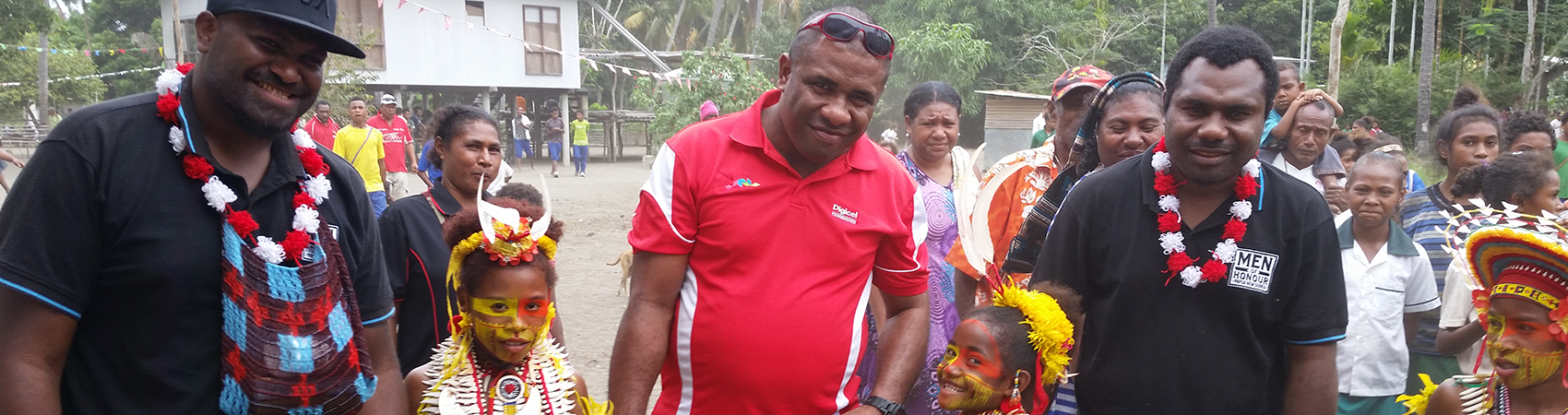 A Digicel Foundation staff member smiling with a child